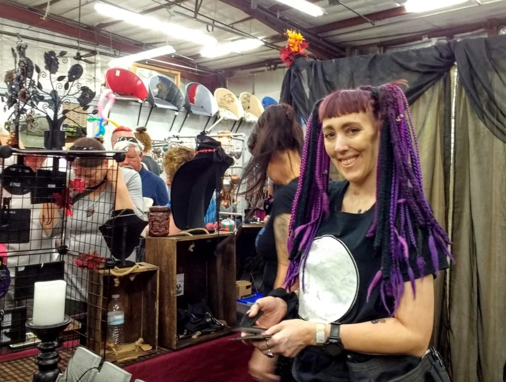 Oddities Market vendor with purple hair