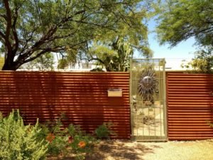 Sunburst gate corrugated garden wall