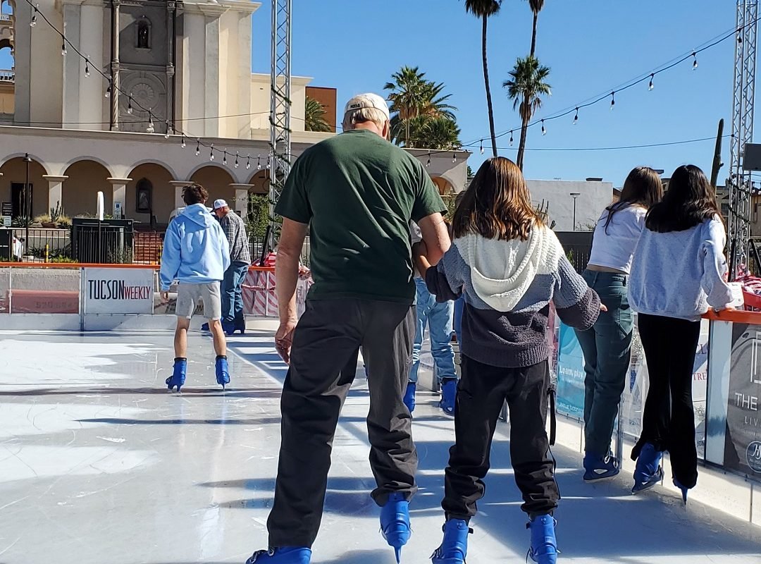 Dad and daughter ice skating in downtown Tucson