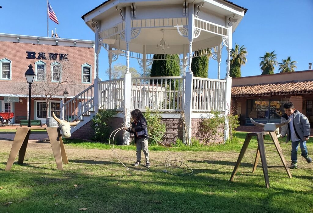 boy and girl roping fake cattle at Dust Trail
Town