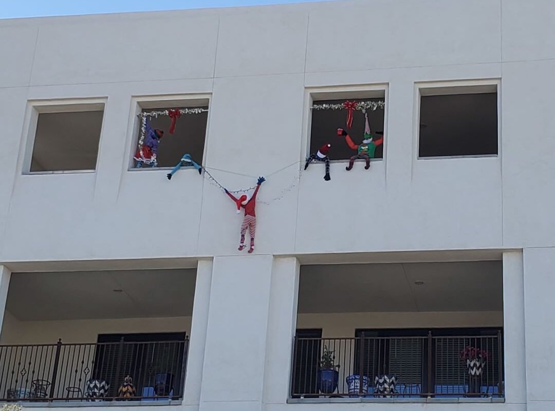 elves hanging from building in Tucson Mercado district