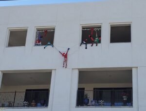 elves hanging from building in Tucson Mercado district