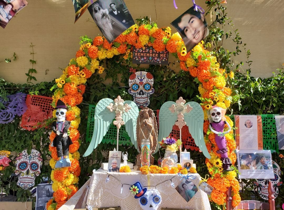 dia de los muertos altar with arch of marigold and two angels