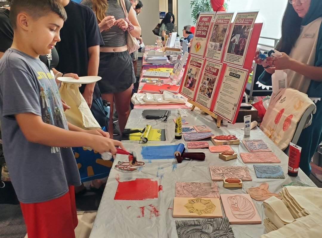 boy inking stamp for book bag printing