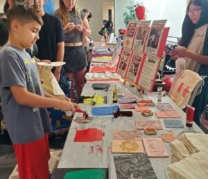 boy inking stamp for book bag printing