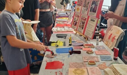 boy inking stamp for book bag printing